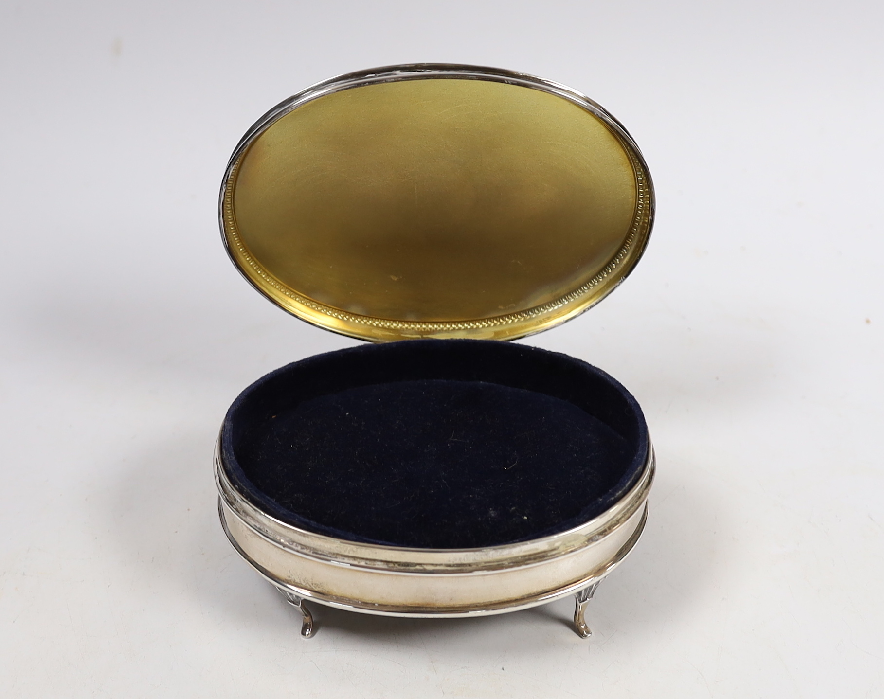 A George V part engine turned silver oval trinket box, Walker & Hall, Birmingham, 1921, 12.8cm.